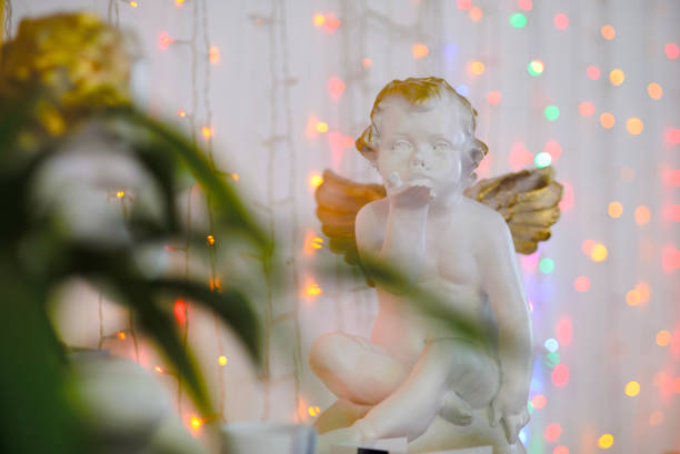 istock Wedding figurine angel against the bright lights 1249283089