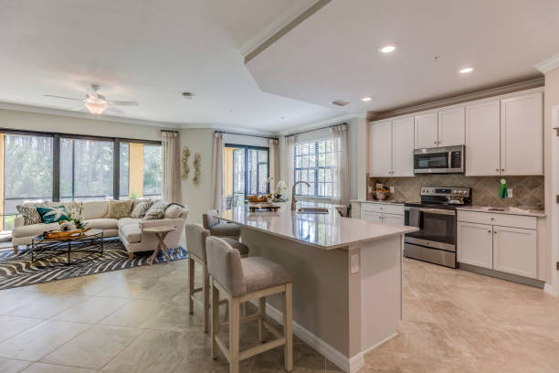 Newly built kitchen in showcase home Open floor plan and white cabinets in modern kitchen open plan stock pictures, royalty-free photos & images