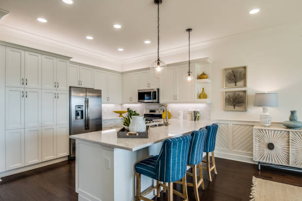 Spacious kitchen with stainless steel appliances Amenities in new kitchen include pull down faucet and pendant lighting bar stool photos stock pictures, royalty-free photos & images