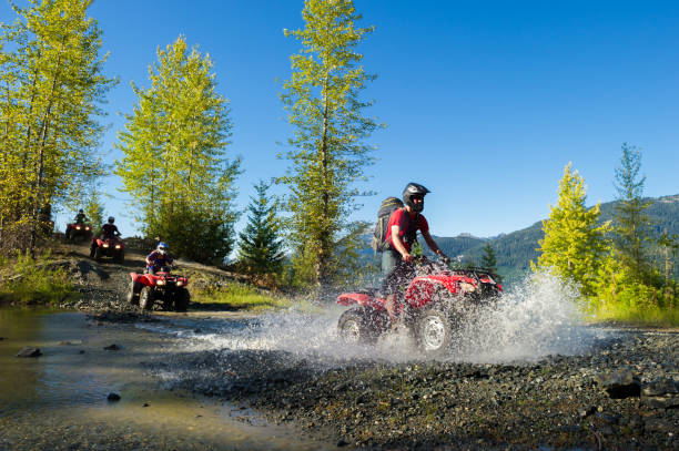 ATV adventure during a mountain holiday ATV adventure in Whistler, BC. Outdoor adventure on a summer vacation. Adreneline adventure in the mountains. quadbike photos stock pictures, royalty-free photos & images