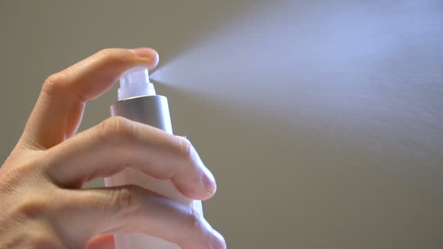 Close-up of the Hand spraying aerosol