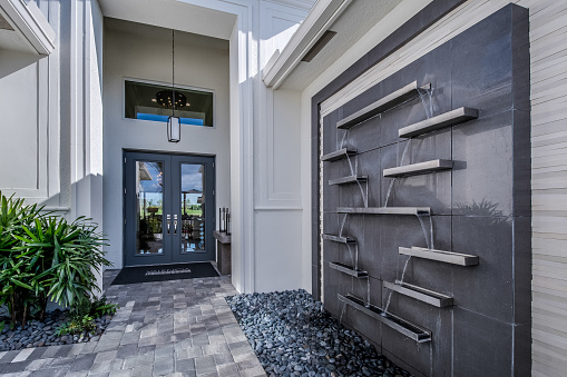 Beautifully landscaped front porch and walkway with waterfall structure