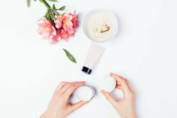 istock Female hands holding open jar cosmetic cream 1249289272
