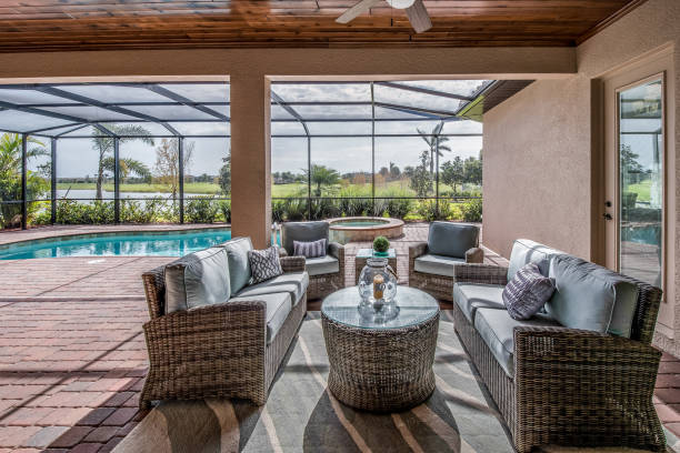 Outdoor poolside gathering area Covered patio with patio furniture for socializing enclosure stock pictures, royalty-free photos & images