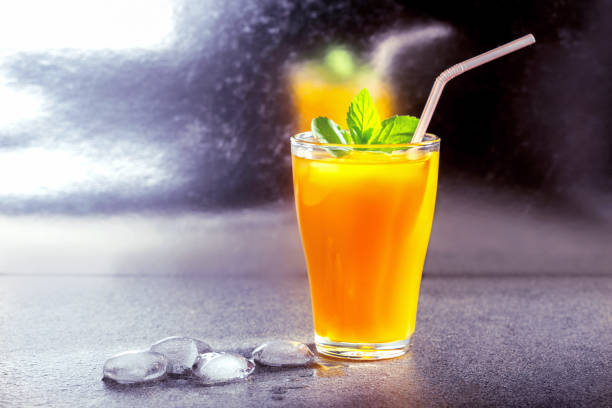 istock Fresh summer cold mango cocktail with lime  on the bar. 1249298040