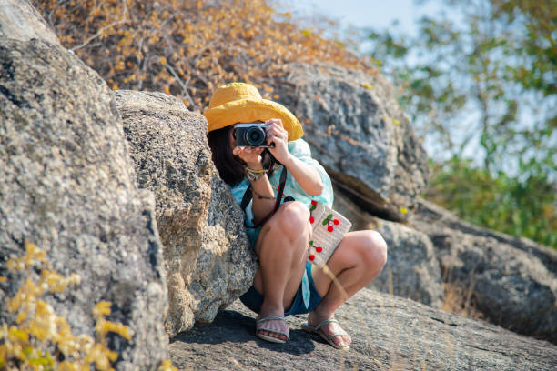 istock Woman hiking in forest on mountain with cliff 1249305425