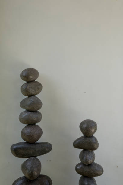 istock Stability and zen balanced stone tower against white wall 1249311115