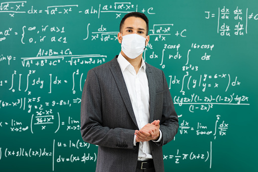 University Professor Standing In Class Wearing Face Mask