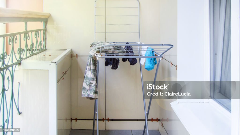 Metal Drying Rack Stands On The Balcony Wet Clothes Are Drying And