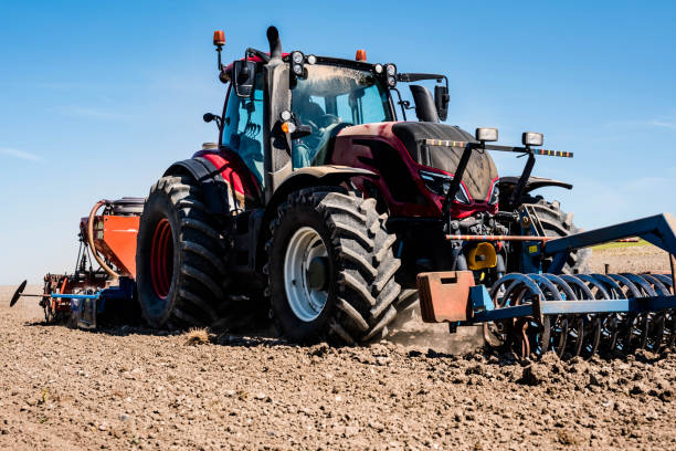 istock farmer in his tractor sowing in the fields 1249318224