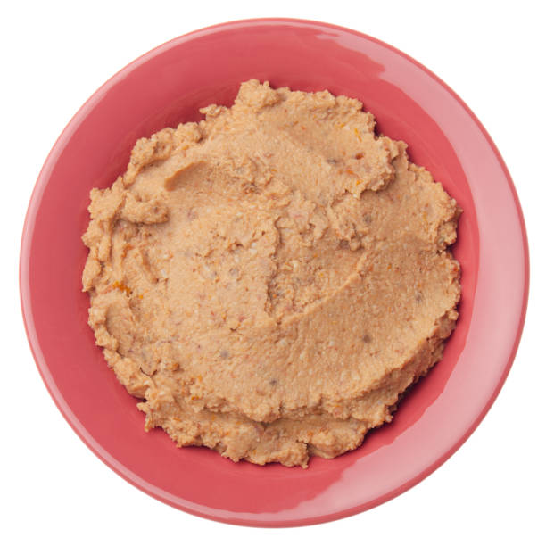 istock Flat lay view at hummus - spread made from cooked, mashed chickpeas blended with tahini, lemon juice, garlic and dried tomatoes isolated on white background 1249320825