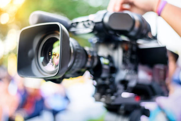 istock Professional cameraman working with digital video camera for live streaming event 1249321554