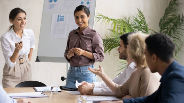 istock Diverse happy colleagues flip charts presentation new project in boardroom. 1249323440