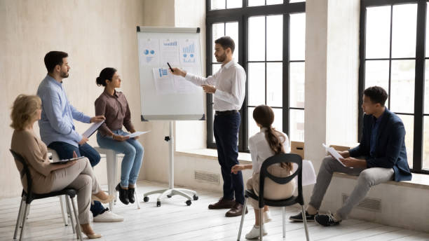 istock Confident bearded businessman flip charts presentation new project in boardroom. 1249323482