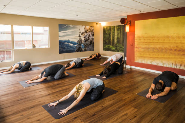 limited people yoga class in studio during covid-19 pandemic. - yoga meditating business group of people imagens e fotografias de stock