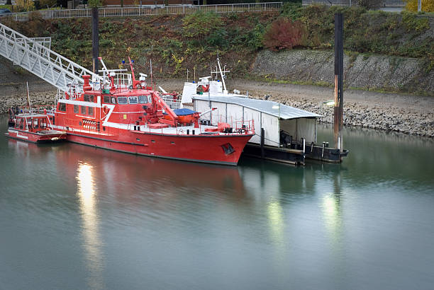 A fire boat anchored in the harbour, early morning, copy space