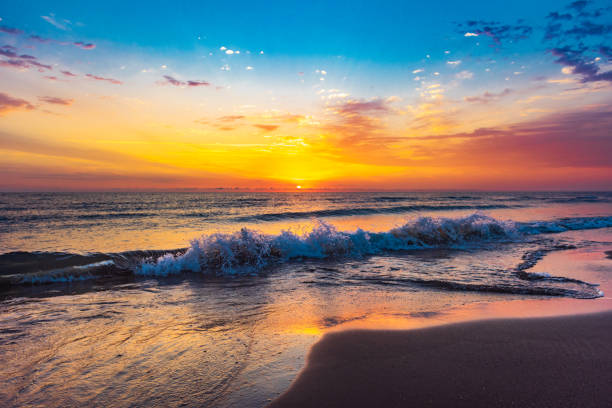 istock Colorful sunrise on the sea beach 1249329485