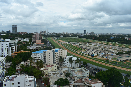 Housing, building, and race field photograph of Indian city