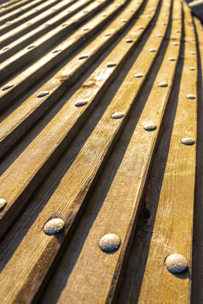 istock long planks horizontal, distant perspective with iron rivets in the sunlight 1249329727
