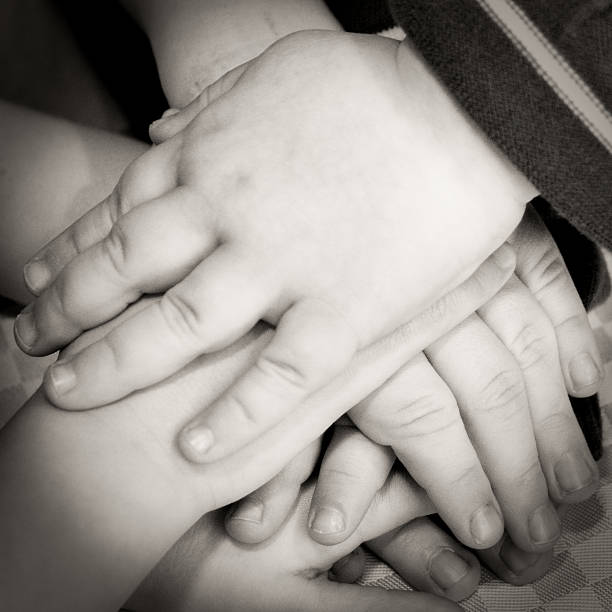 istock Kids hands, making a pact - sepia toned, spotlit 124932973