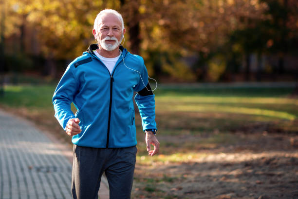 istock Active senior runner jogging outdoors 1249331030