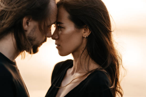 istock Bluerd Attractive man and woman enjoying romantic evening on sunset 1249331447