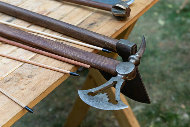 istock ax combat openwork blade, arrow bow on the background of maces on the table assortment of weapons 1249333199