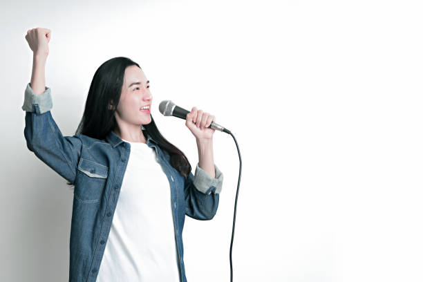 istock Asian woman holding microphone on isolated white 1249334118