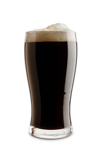 glass of dark beer with foam, isolated on white background