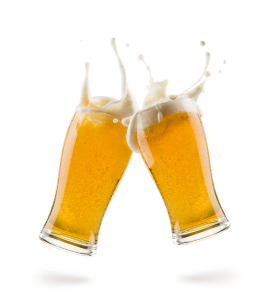 lager beer two glasses of lager beer bumping on white background with shadow celebratory toast stock pictures, royalty-free photos & images
