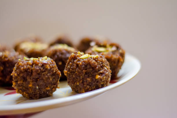 Fresh Homemade ladoo or laddu, made by bread crumbs with pistachio on it, with selective focus Fresh Homemade ladoo or laddu, made by bread crumbs with pistachio on it, with selective focus rawa island stock pictures, royalty-free photos & images