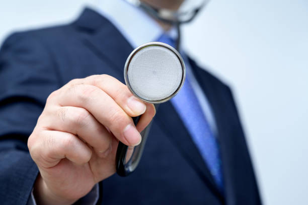 istock Businessman holding a stethoscope in his hand. 1249336816