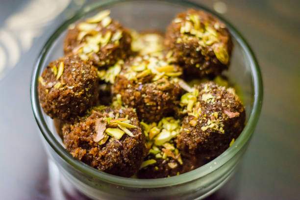 Fresh Homemade ladoo or laddu, made by bread crumbs with pistachio on it, with selective focus Fresh Homemade ladoo or laddu, made by bread crumbs with pistachio on it, with selective focus rawa island stock pictures, royalty-free photos & images