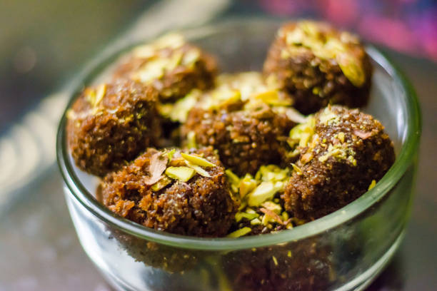 Fresh Homemade ladoo or laddu, made by bread crumbs with pistachio on it, with selective focus Fresh Homemade ladoo or laddu, made by bread crumbs with pistachio on it, with selective focus rawa island stock pictures, royalty-free photos & images