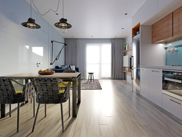 istock small studio apartment with kitchen, dining room and living room with sofa. Interior in blue and white colors and wooden elements. 1249340294