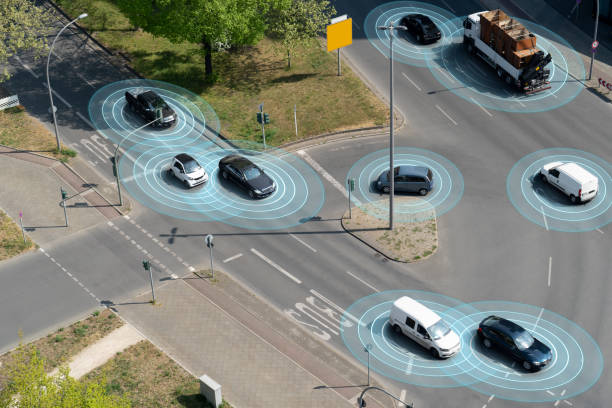 Self Driving Autonomous Cars on City Street Self driving autonomous cars on multi lane city street. The cars are using radar sensors, wireless communication, GPS and artificial intelligence to navigate and communicate with each other. driverless car stock pictures, royalty-free photos & images