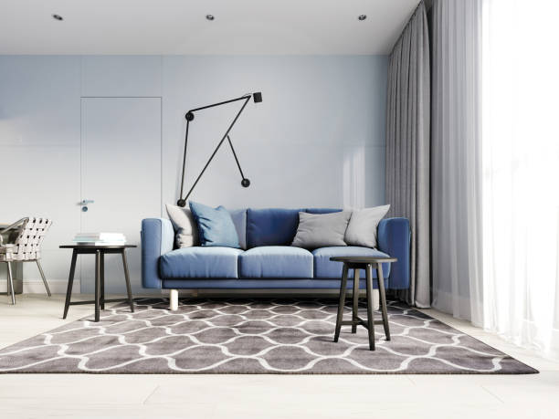 istock Nordic design living room with a modern blue sofa and black side tables with decor. Scandinavian contemporary style. Design hinged wall lamp. 1249340326