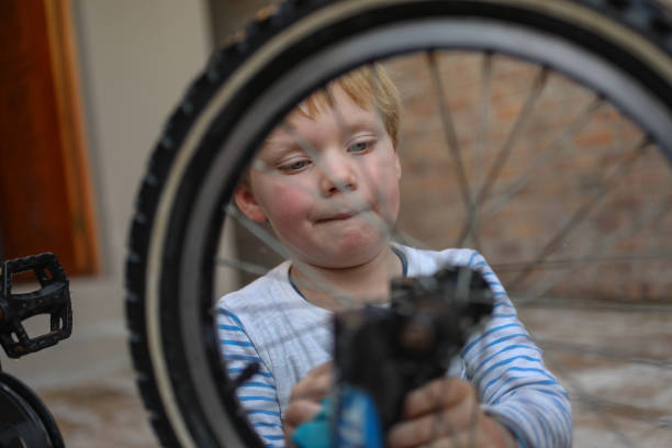 istock A young boy washes his bike. 1249341417