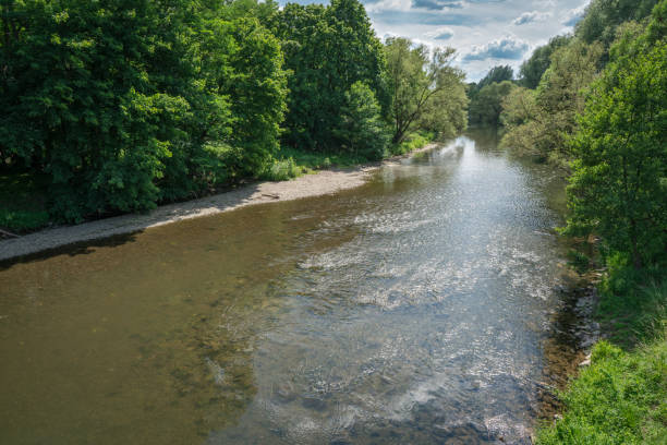 istock Looking down the river towards the sun with reflections on the water.A scene on a beautiful summer day. 1249341419