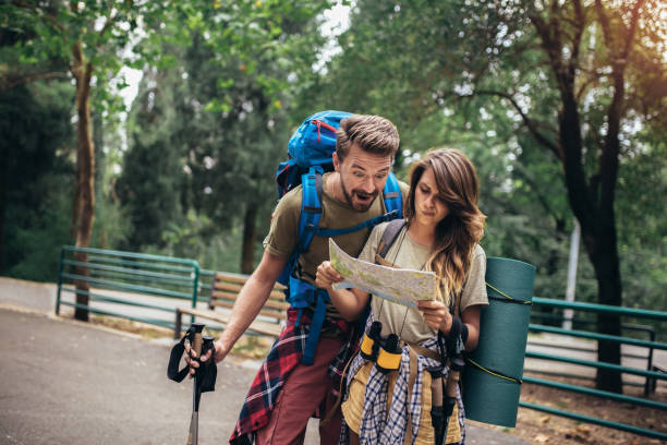 istock Couple hiking trough forest. Using map to get good direction. 1249341713
