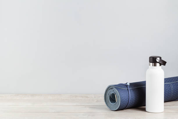 istock Rolled yoga mat and metal water bottle 1249341834
