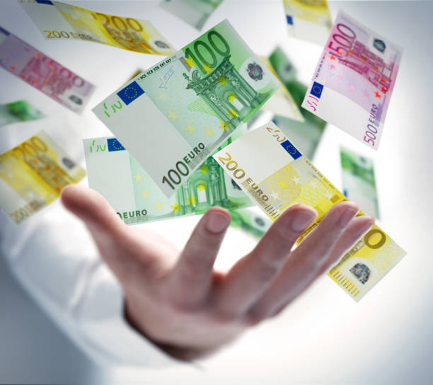 Hand with banknotes Male hand with flying 100 Euro notes jackpot photos stock pictures, royalty-free photos & images