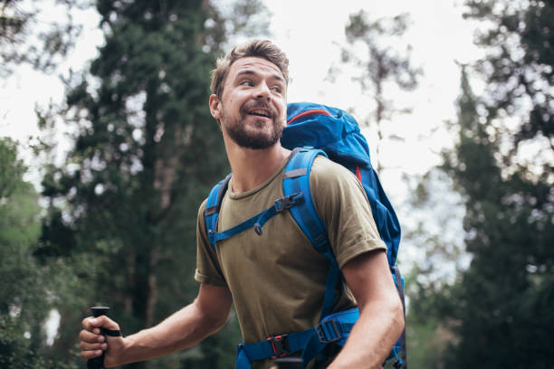 istock Hiker man with backpack walking in forest in summer. 1249342994