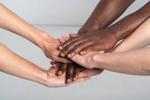 istock Studio shot of unrecognizable group of mixed race people holding hands 1249343585