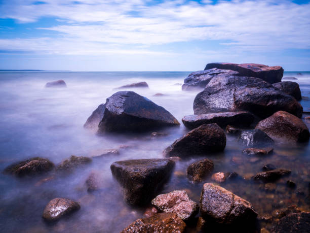 Tranquil landscape with smooth flowing white waves in the turquoise-colored seawater