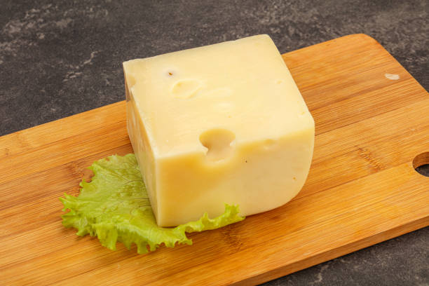 istock Emmental cheese over wooden board 1249344860