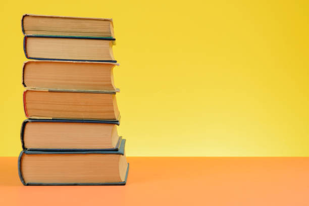 istock Vintage Books on Colored Paper Background. 1249346132