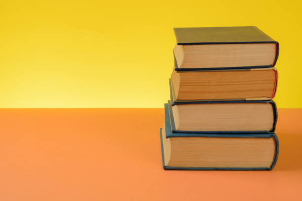 istock Vintage Books on Colored Paper Background. 1249346147