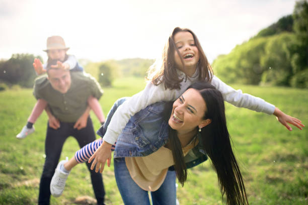 istock Happy family with two small daughters having fun outdoors in spring nature. 1249347358