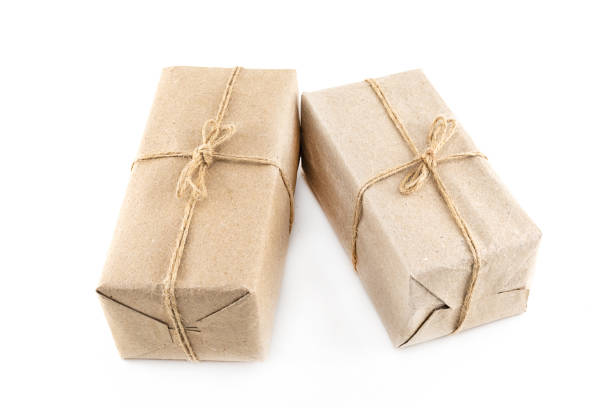 istock two festive giftbox packed in craft paper on an isolated background 1249348370